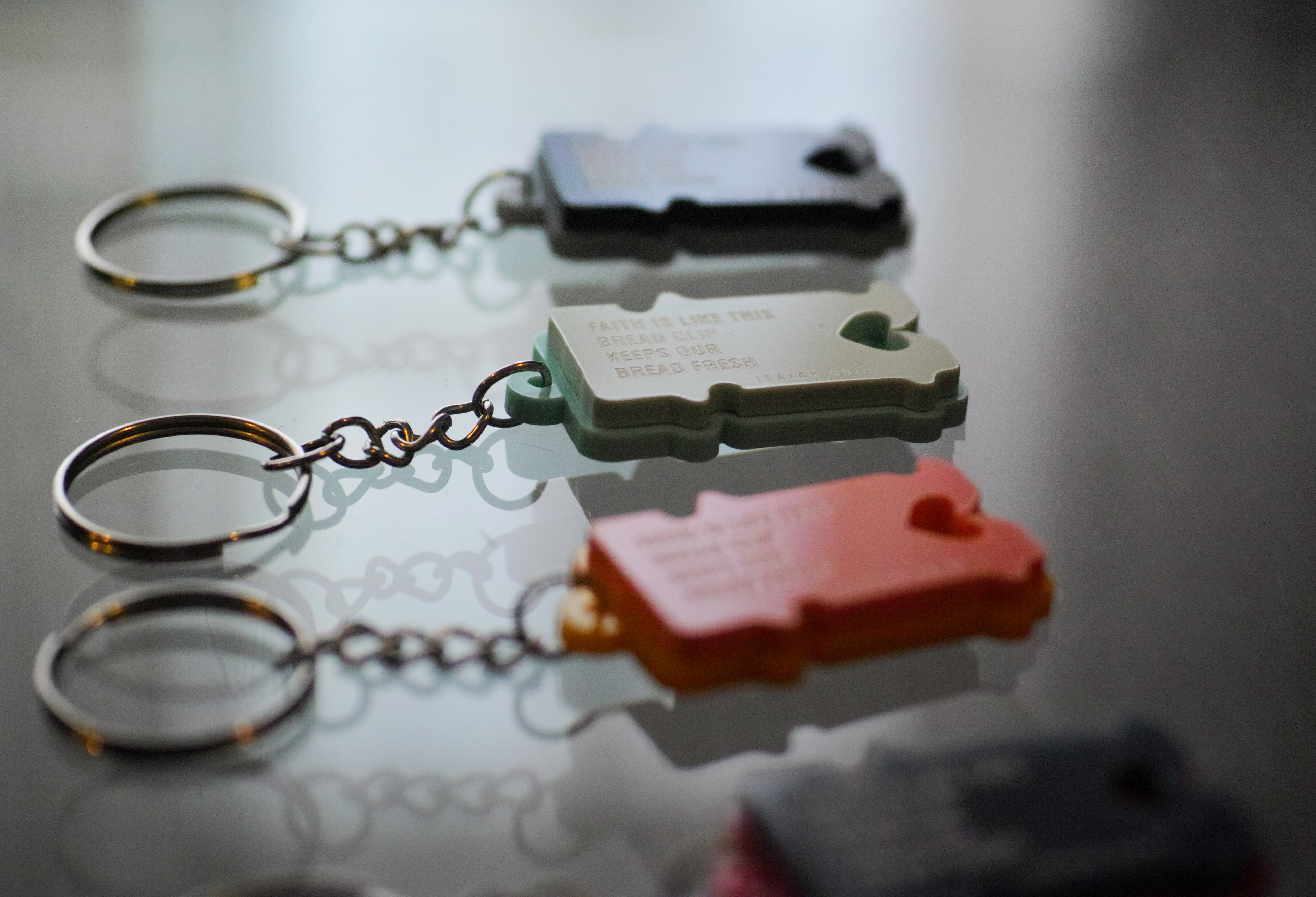 Four keychains with different designs on a polypropylene.